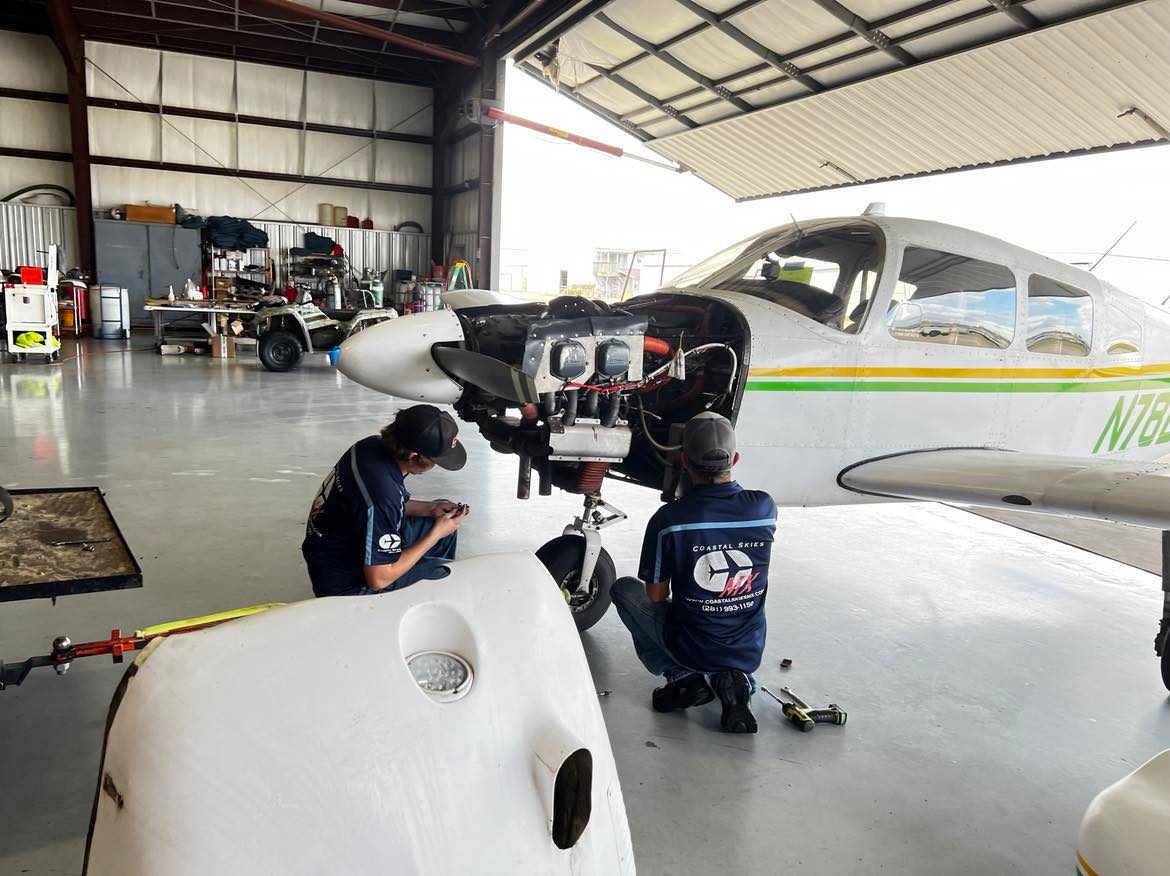 aircraft hangar with aircraft mechanics