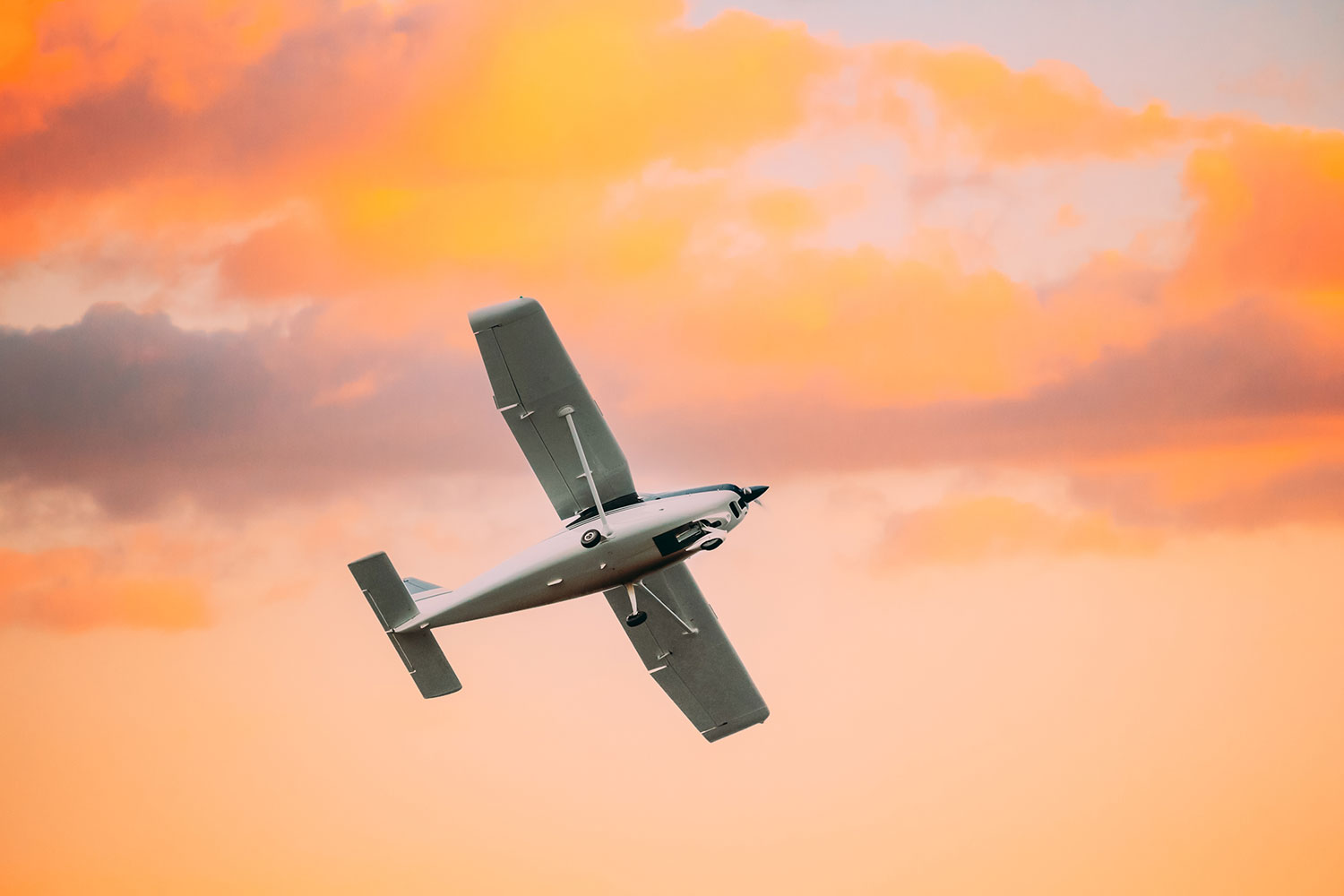 Light aircraft flying in the sunrise